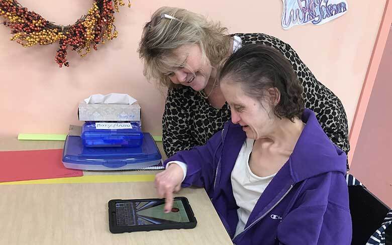 A woman learning to use electronics technology as part of the Medical Special Needs Day Program at Abilities