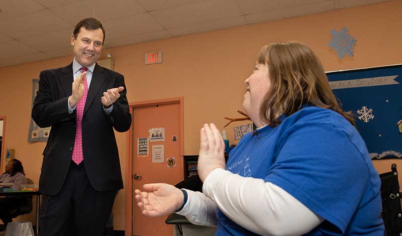 Congressman Kean and an individual clapping in participation of the music enrichment program.