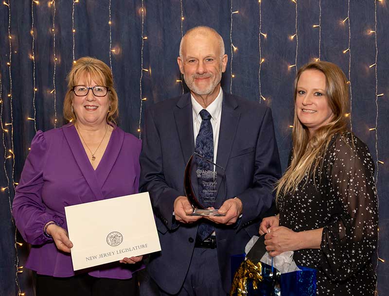 John Schmidt, center, receives the Volunteer Award during Abilities of Northwest Jersey, Inc.’s annual Diamonds in the Sky gala on April 22 at the Architects Golf Club in Lopatcong, NJ. With Schmidt are Abilities CEO Cynthia B. Wildermuth (left) and Mission Engagement Manager Charissa Buskirk (right).